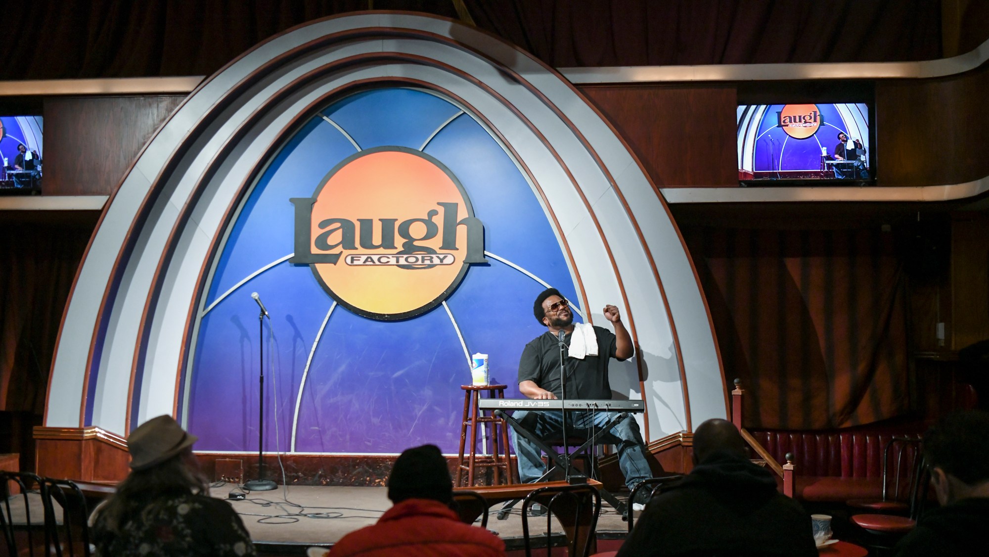 A view of the inside of the Laugh Factory in West Hollywood with comedian Craig Robinson performing on stage.