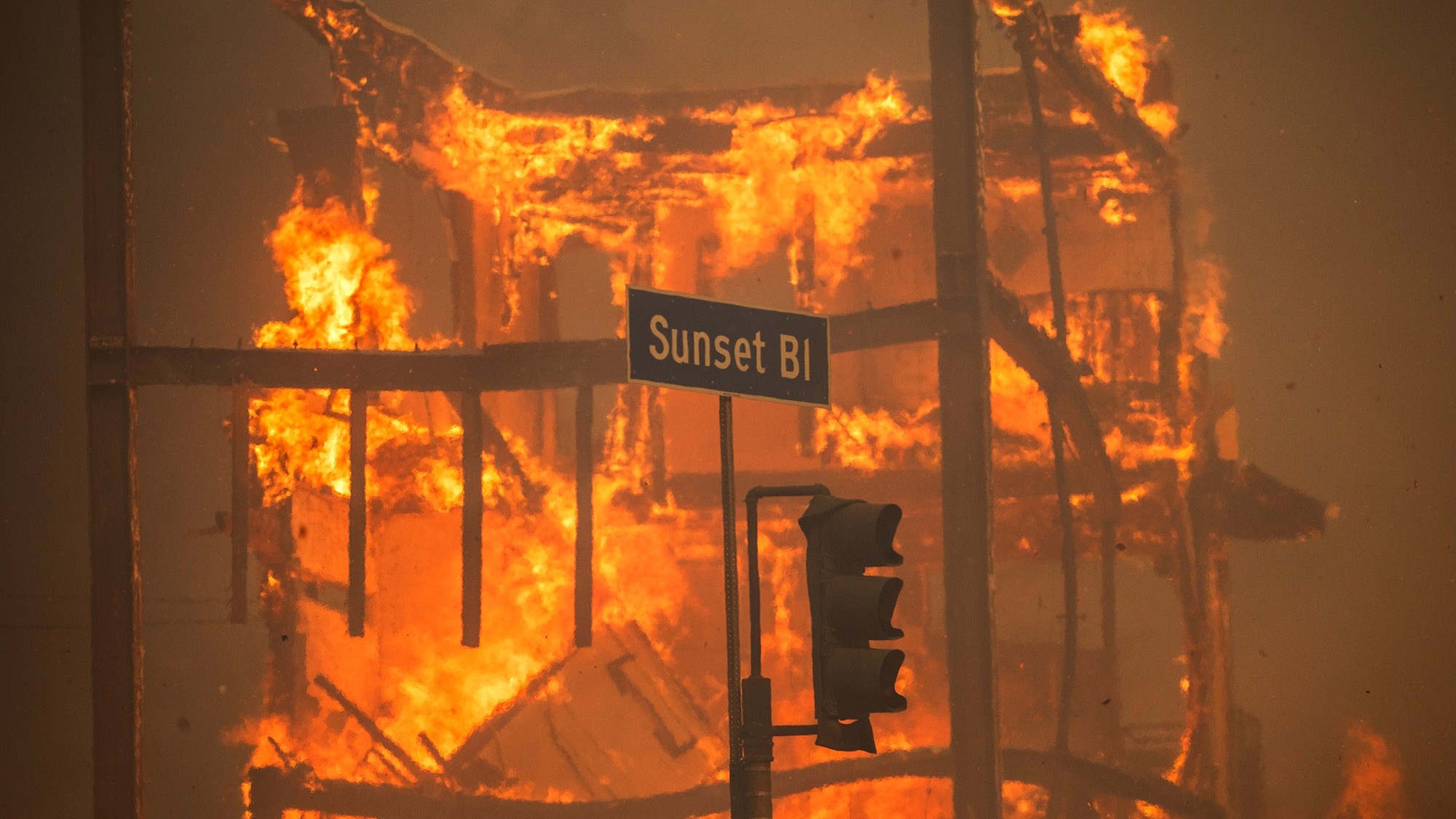 Flames from the Palisades Fire burn a building on Sunset Boulevard amid a powerful windstorm on January 8, 2025 in the Pacific Palisades neighborhood of Los Angeles, California.