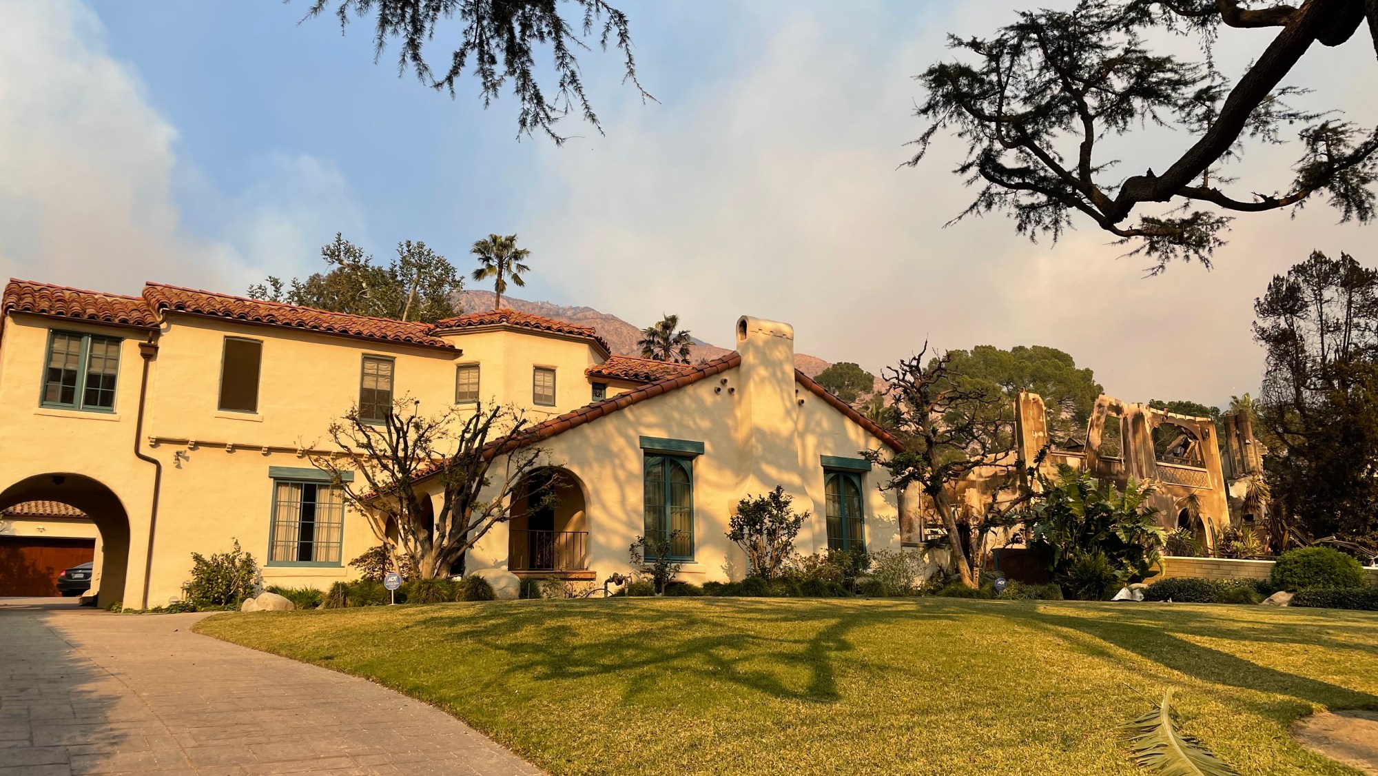 "Casa Walsh," the family home made famous on the 1990s show "Beverly Hills, 90210," remains intact in Altadena, while the property next door was destroyed by the ongoing Eaton Fire.